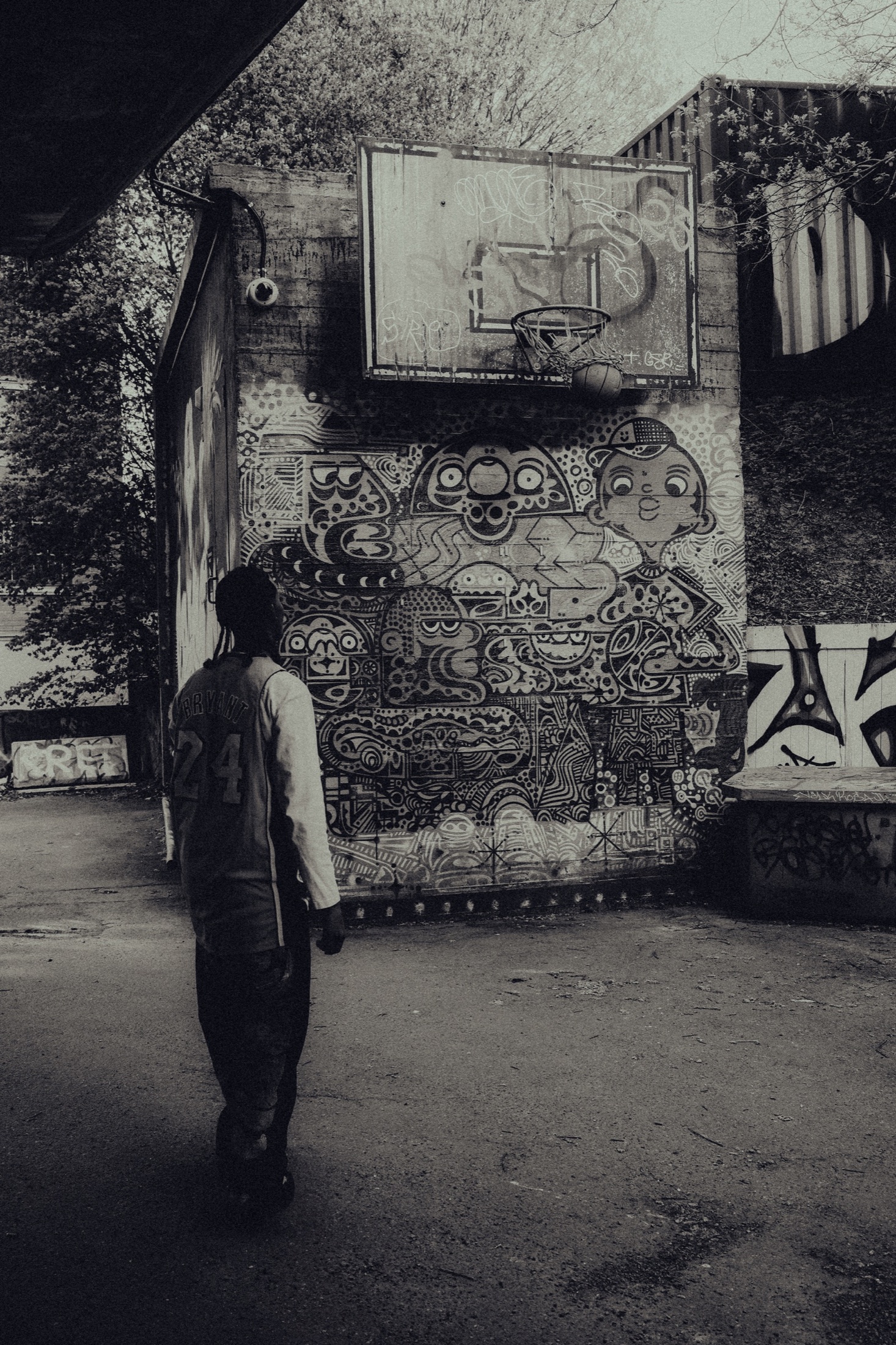 Artist standing in front of a mural